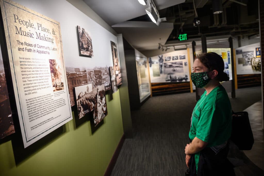 Tour participant walking through an exhibit