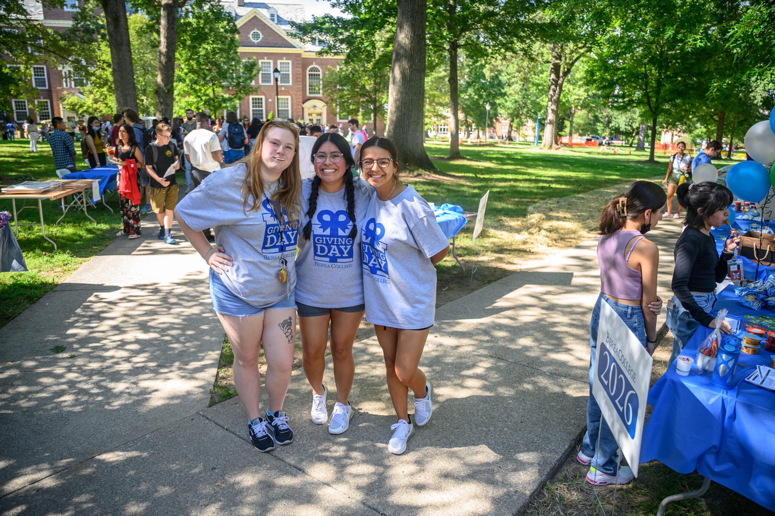 Three students in front of Draper wearing "Berea College Giving Day" shirts