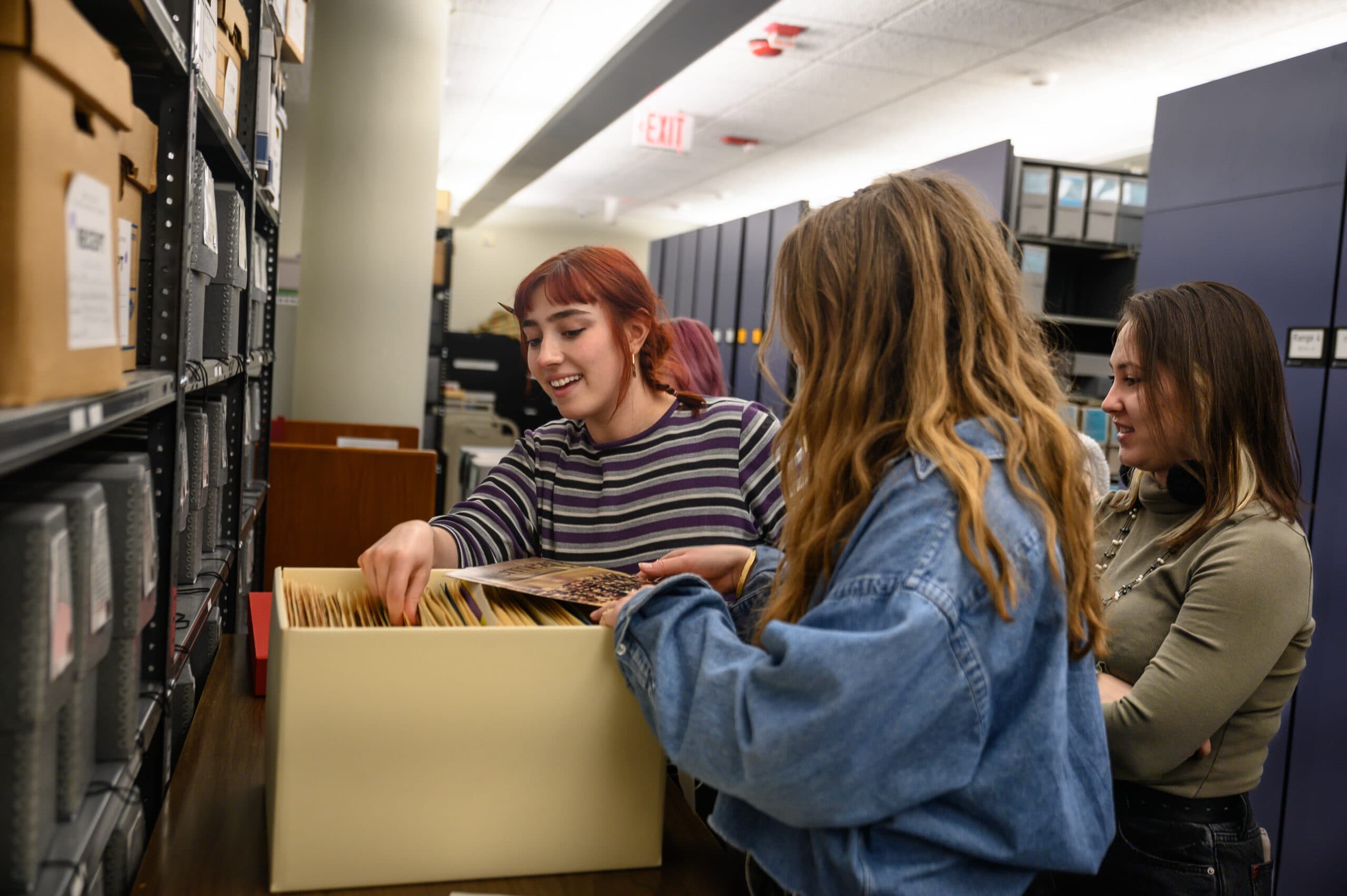 Female students looking through the Janis Ian archives in Hutchins Library.